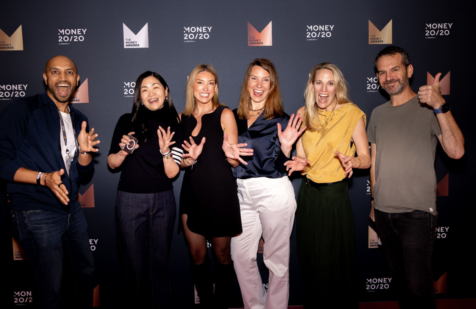 Group of attendees laughing on the Money Awards red carpet